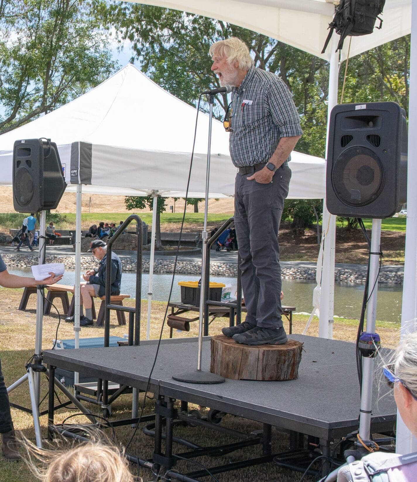 Dr. Steve Quarles standing on a stage, speaking into a microphone with his hands in his pockets.