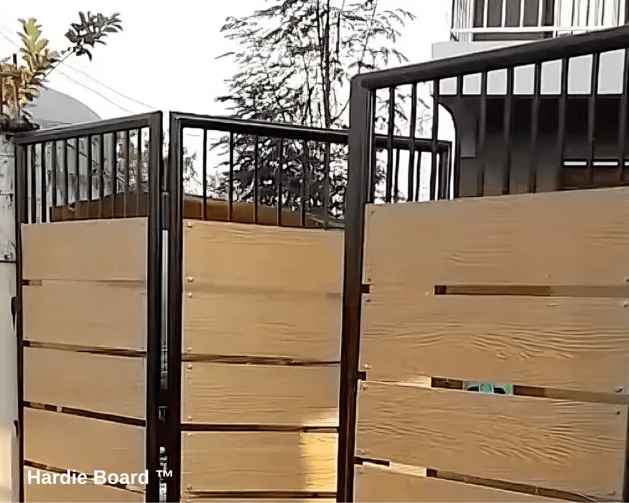 A steel fence with fiber cement boards, made to look like painted wood, on the bottom.