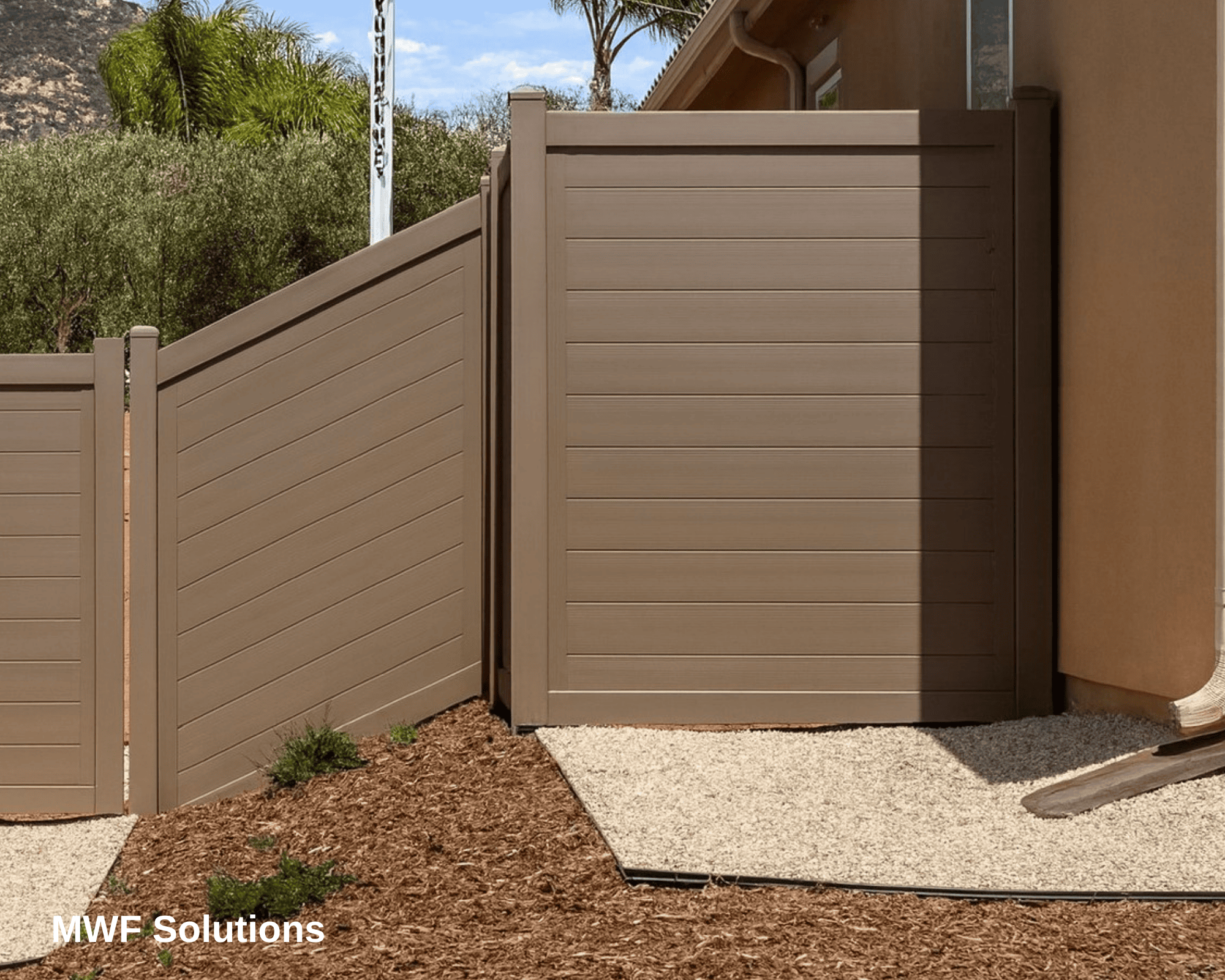 A larger steel fence, painted to look like wooden boards.