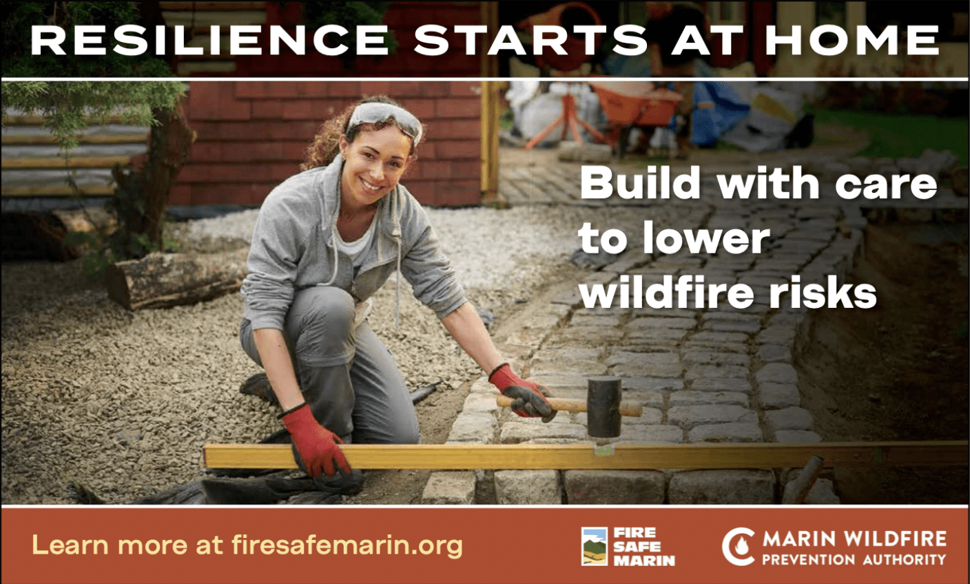 Photo of a woman laying pavers on a pathway using a mallet.