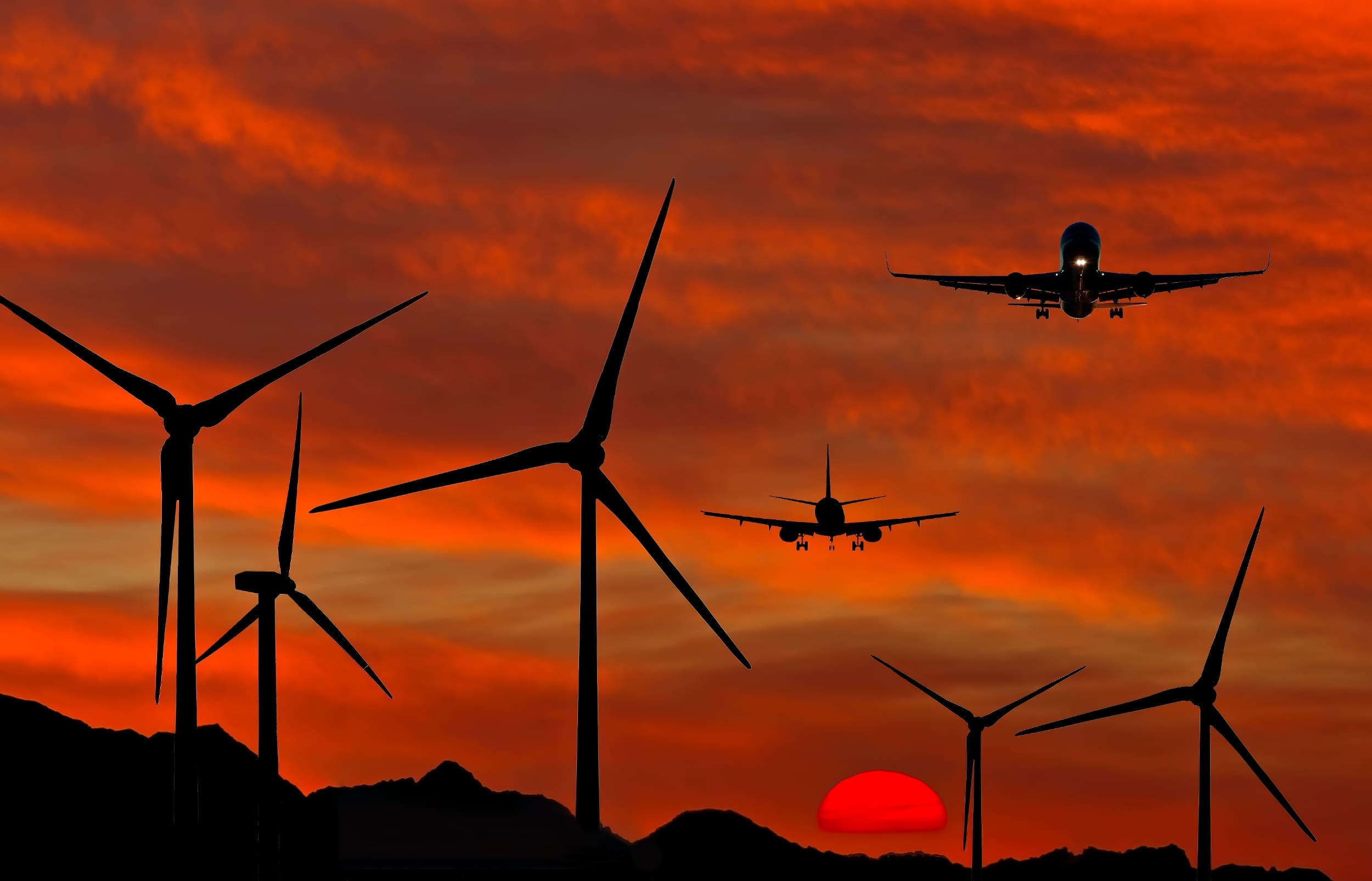 plane flying in orange sky