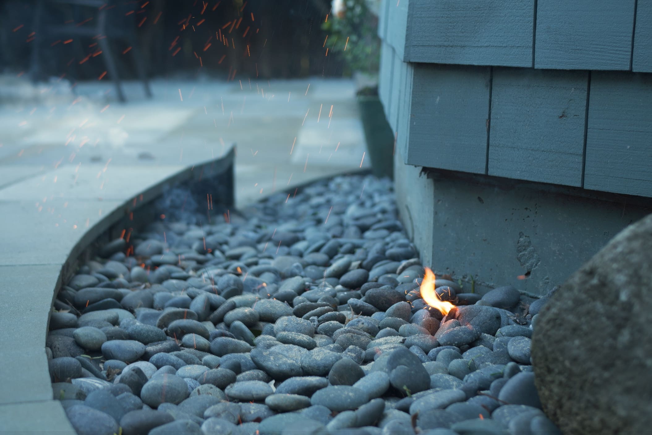 fire outside of house on rocks