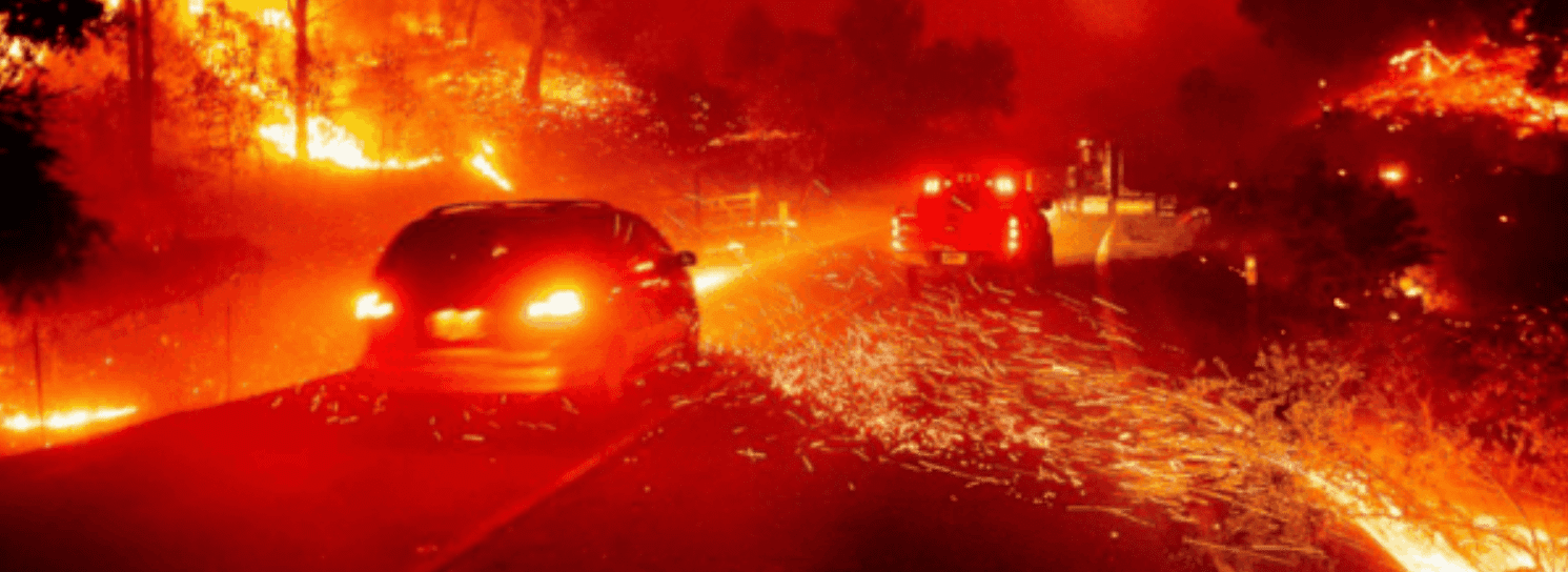 road on fire with car driving through it
