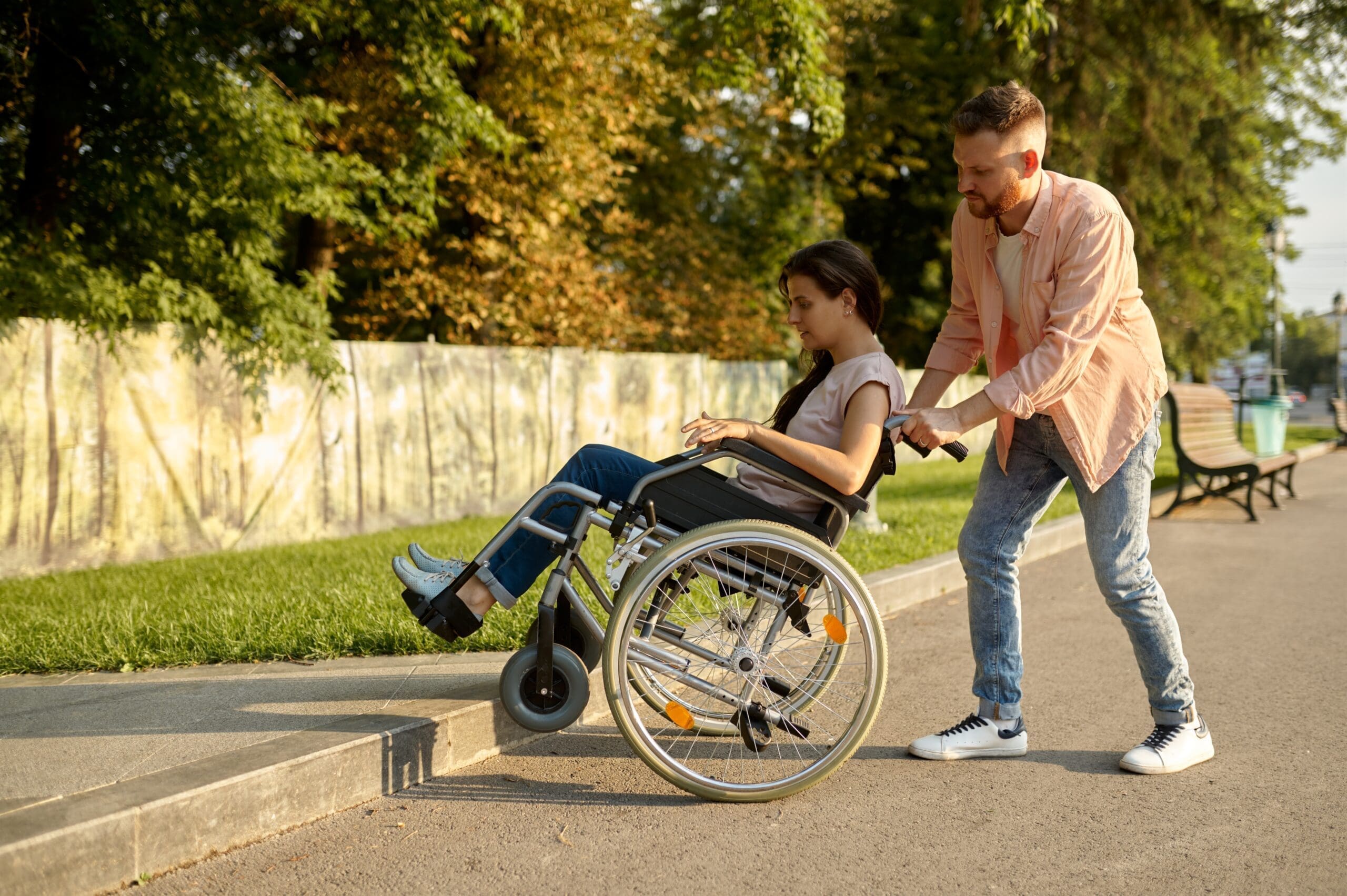 Family,Couple,With,Wheelchair,Overcomes,The,Curb