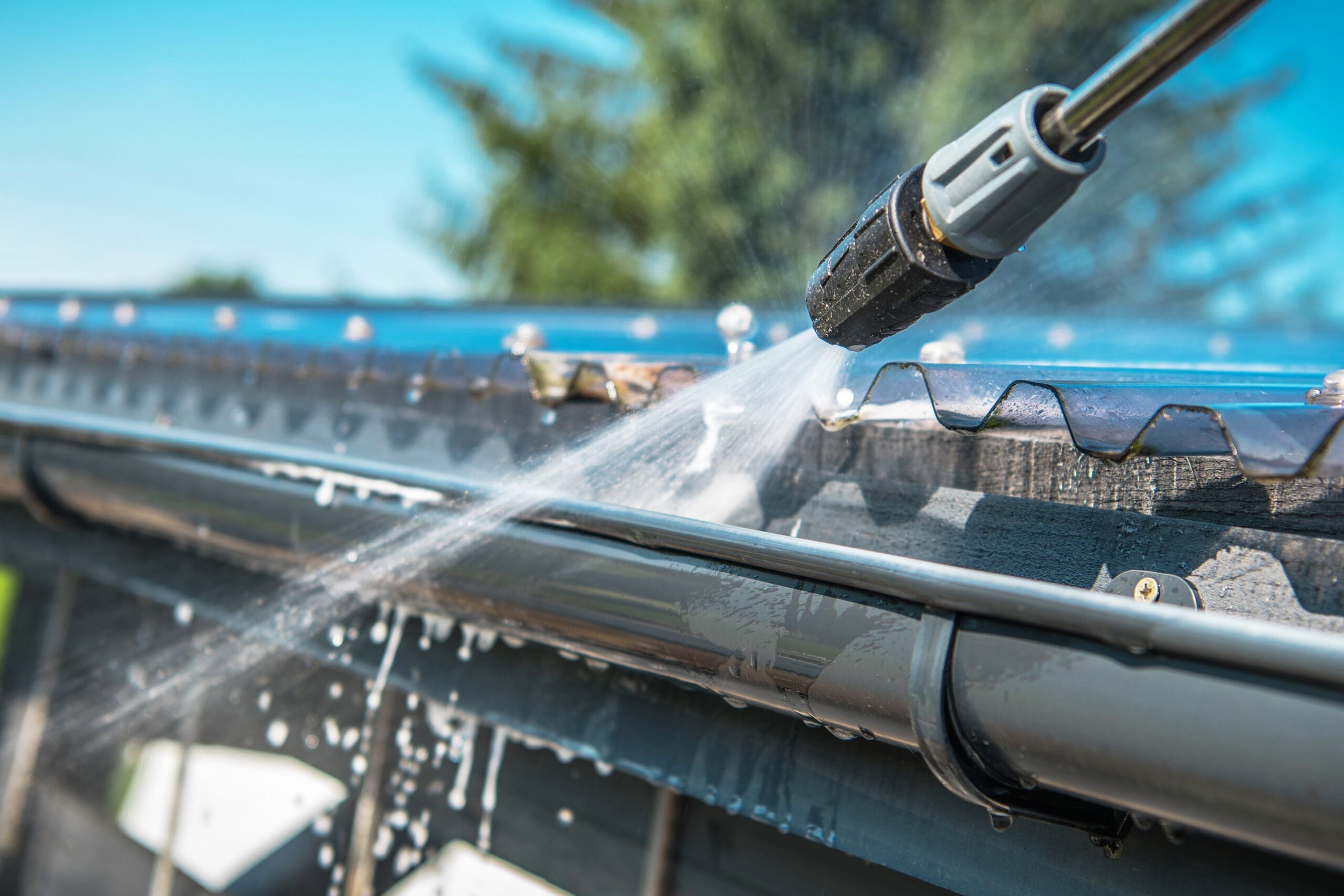 Spring,Rain,Gutters,Cleaning,Using,Pressure,Washer.,Closeup,Photo.