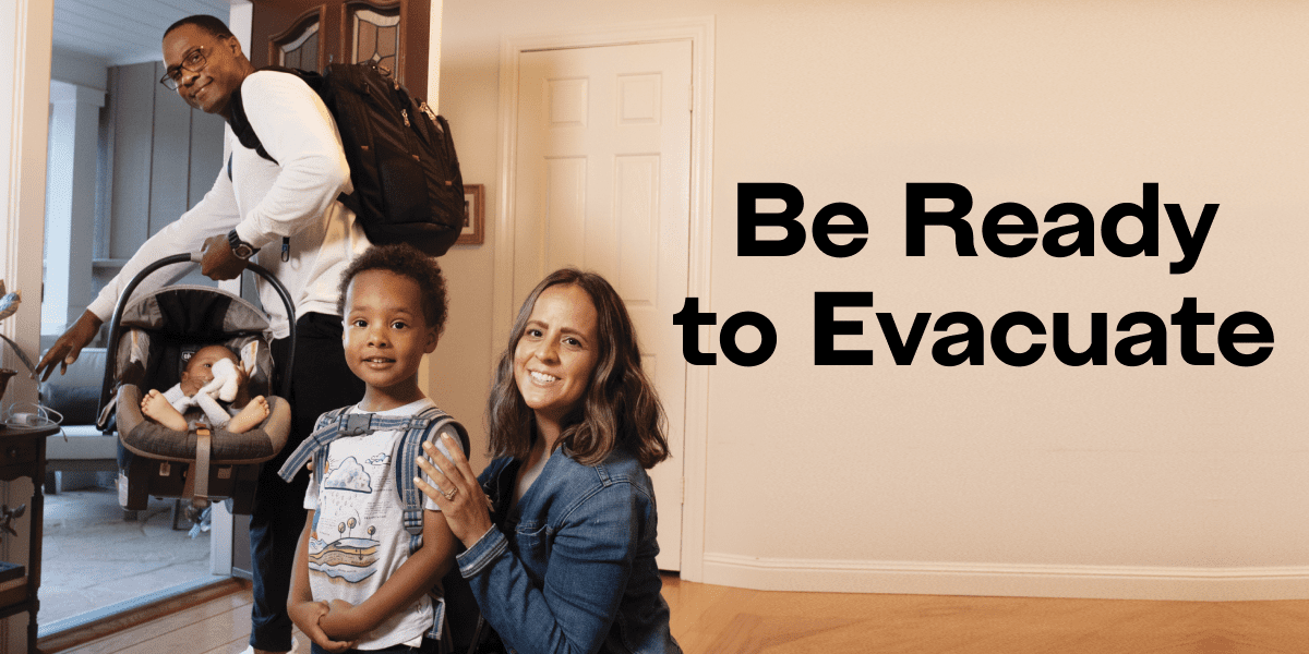 Family leaving home with baby in car seat and little boy with backpack. "Be Ready to Evacuate"