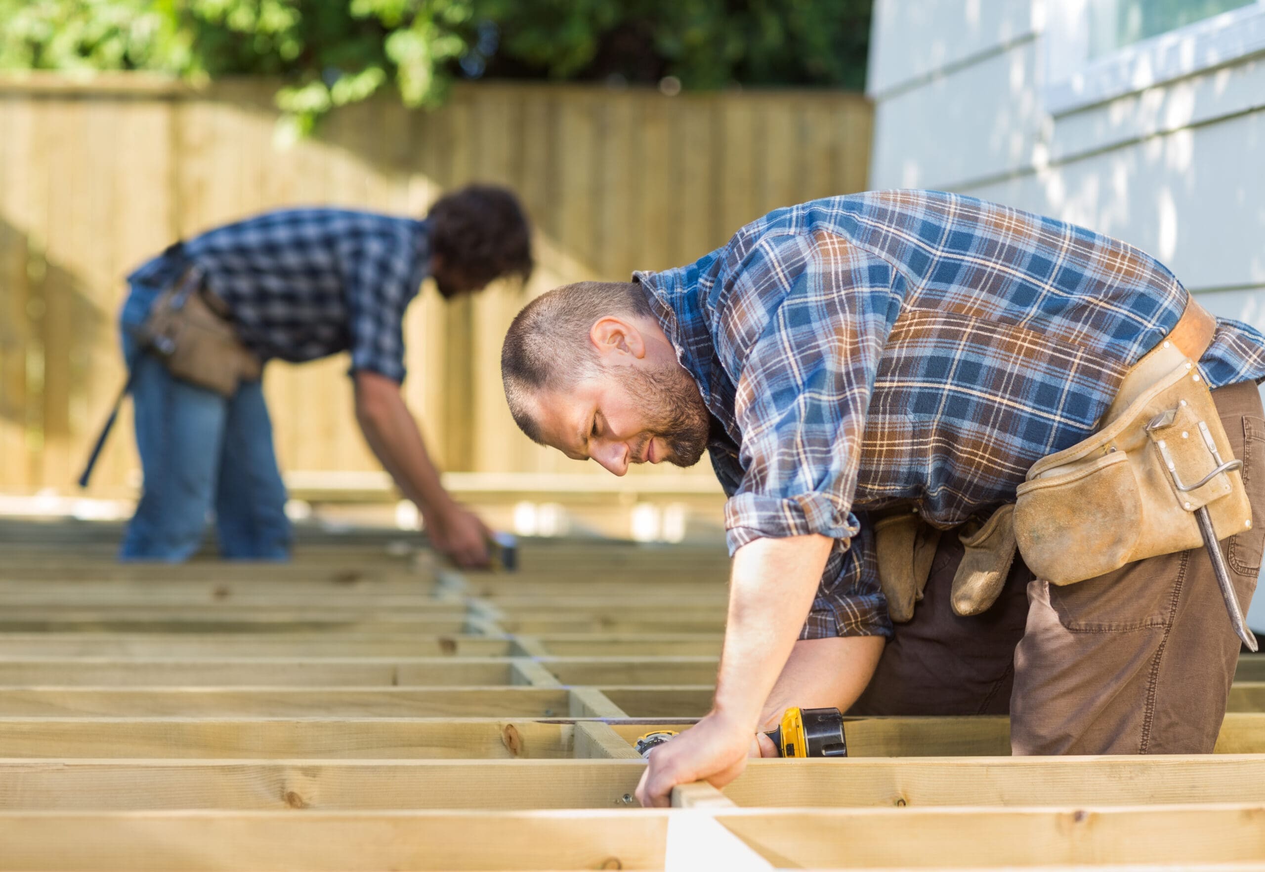Side,View,Of,Mid,Adult,Carpenters,Working,At,Construction,Site